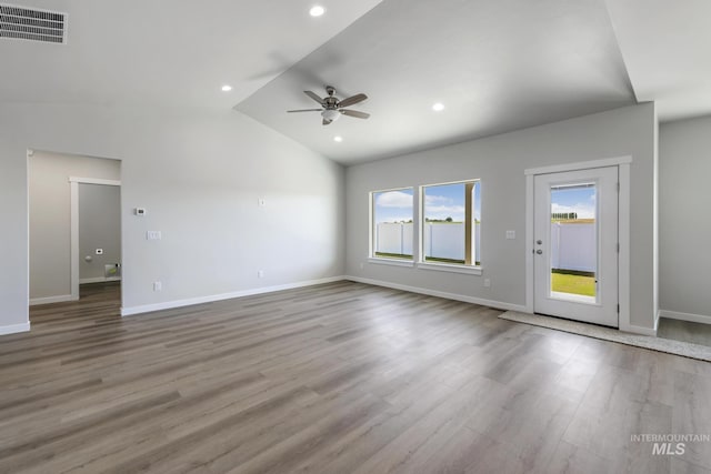 unfurnished living room featuring ceiling fan, lofted ceiling, and light wood-type flooring