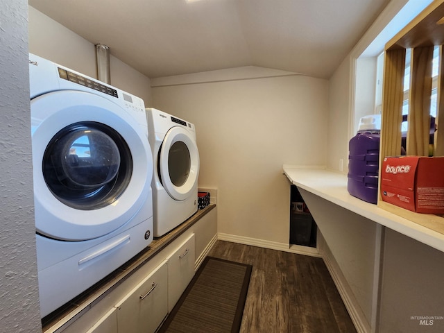 clothes washing area featuring baseboards, washer and clothes dryer, and dark wood-style flooring