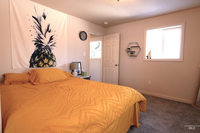 bedroom featuring carpet and baseboards