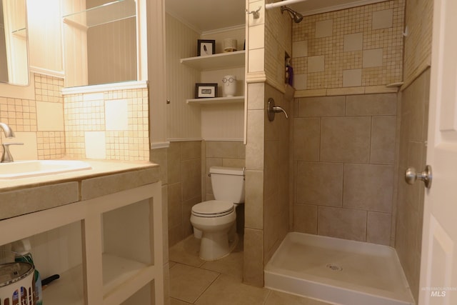 bathroom featuring crown molding, tile walls, toilet, a shower stall, and tile patterned floors