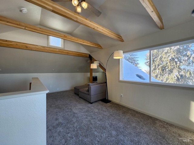 additional living space with lofted ceiling with beams, dark carpet, and baseboards