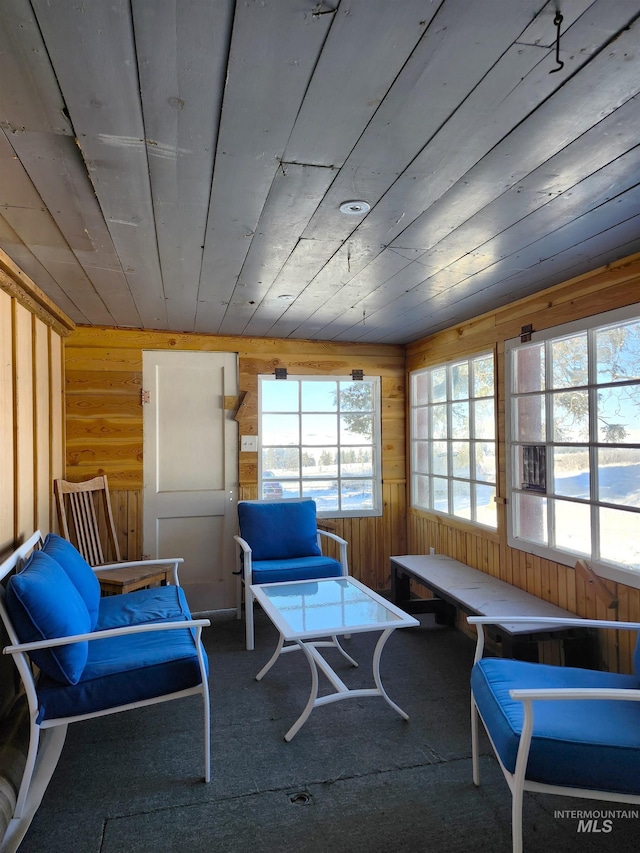 sunroom / solarium featuring plenty of natural light and wooden ceiling