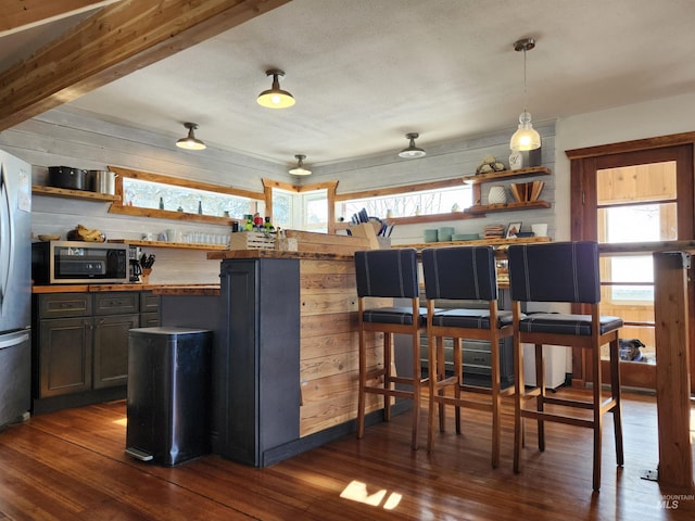 kitchen with stainless steel appliances, wood counters, hanging light fixtures, dark wood-style floors, and open shelves