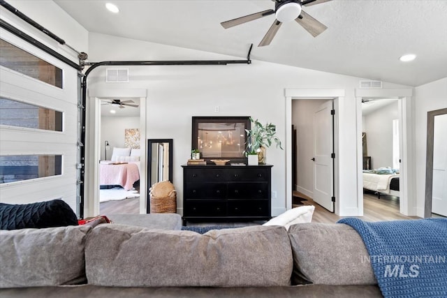 362-436 W London St, Middleton, ID 83644 - living room featuring lofted ceiling, light wood-style flooring, visible vents, and recessed lighting