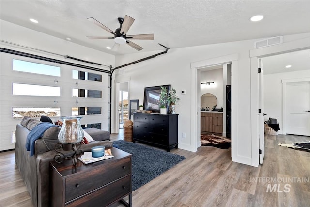362-436 W London St, Middleton, ID 83644 - living area featuring a textured ceiling, plenty of natural light, visible vents, and light wood-style floors