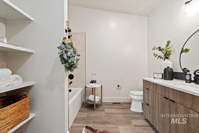 362-436 W London St, Middleton, ID 83644 - bathroom featuring shower / bath combination, toilet, vanity, wood finished floors, and baseboards