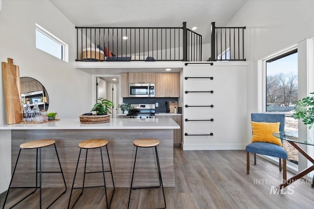 362-436 W London St, Middleton, ID 83644 - kitchen with a breakfast bar area, a wealth of natural light, light countertops, appliances with stainless steel finishes, and a peninsula