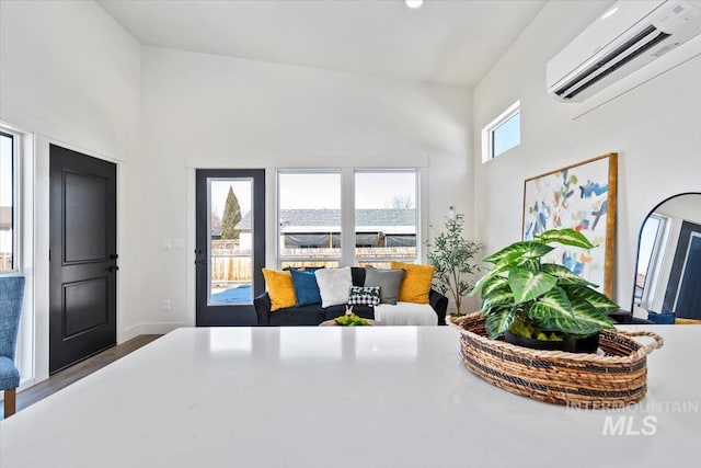 362-436 W London St, Middleton, ID 83644 - interior space featuring a wall unit AC, a towering ceiling, and dark wood-style flooring