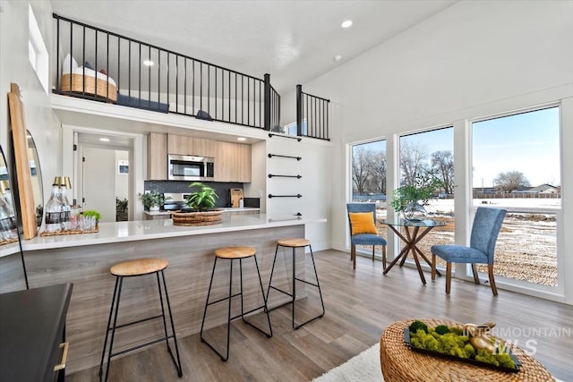 362-436 W London St, Middleton, ID 83644 - kitchen with a breakfast bar, light countertops, appliances with stainless steel finishes, light wood-style floors, and modern cabinets