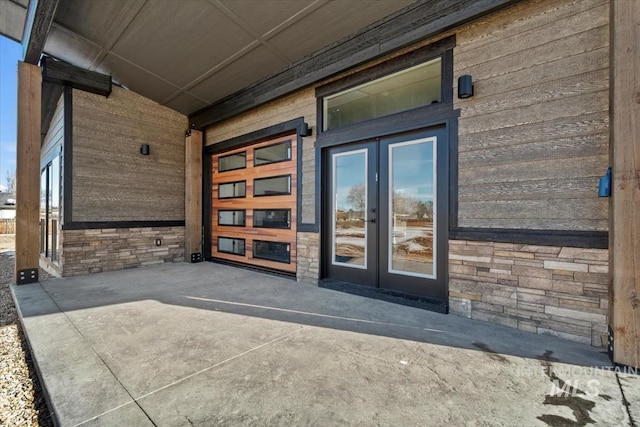 362-436 W London St, Middleton, ID 83644 - view of exterior entry with stone siding, a patio area, and french doors