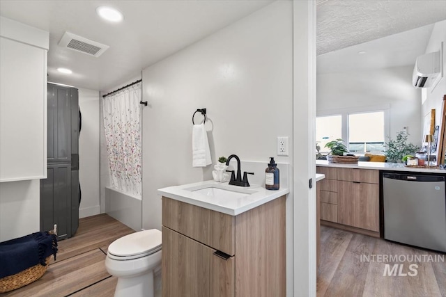 362-436 W London St, Middleton, ID 83644 - full bathroom featuring wood finished floors, vanity, visible vents, a wall mounted air conditioner, and shower / bathtub combination with curtain