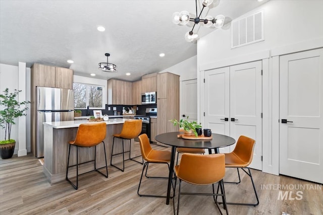 362-436 W London St, Middleton, ID 83644 - kitchen featuring appliances with stainless steel finishes, light countertops, hanging light fixtures, and modern cabinets