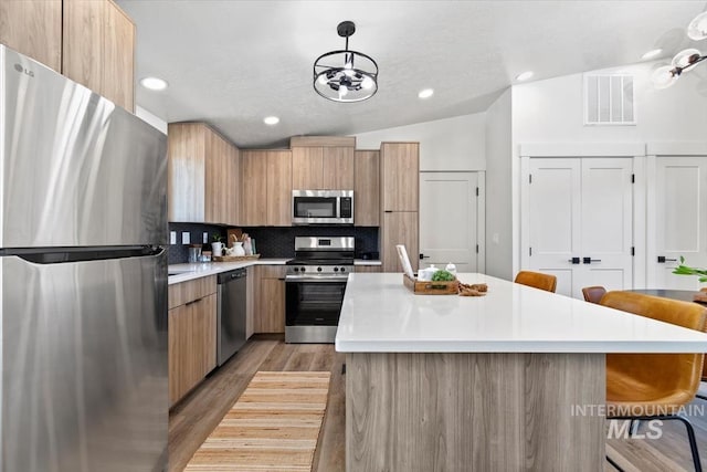362-436 W London St, Middleton, ID 83644 - kitchen with stainless steel appliances, a kitchen island, light countertops, modern cabinets, and pendant lighting