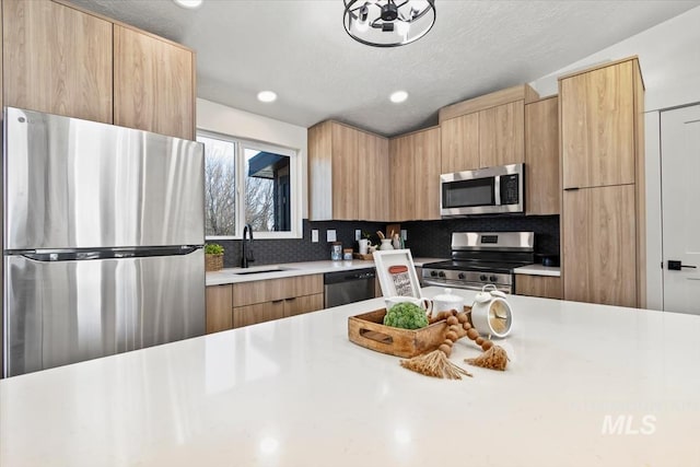 362-436 W London St, Middleton, ID 83644 - kitchen with stainless steel appliances, a sink, light countertops, backsplash, and modern cabinets