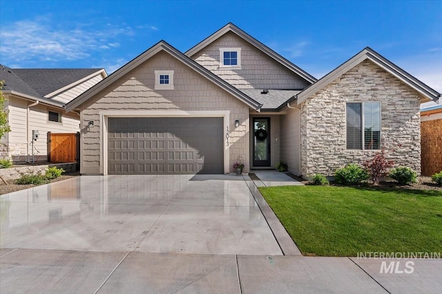 12013 W Zamalek Ct, Kuna, ID 83634 - view of front of house with an attached garage, stone siding, concrete driveway, and a front yard