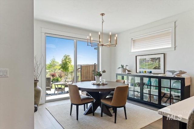 12013 W Zamalek Ct, Kuna, ID 83634 - dining space with a chandelier and wood finished floors