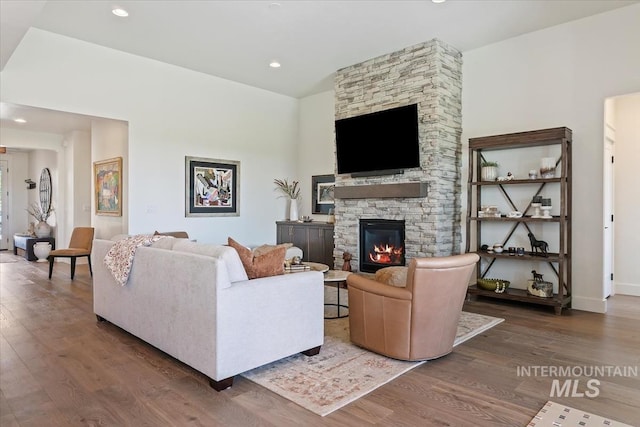 12013 W Zamalek Ct, Kuna, ID 83634 - living room featuring wood finished floors, a fireplace, recessed lighting, and baseboards