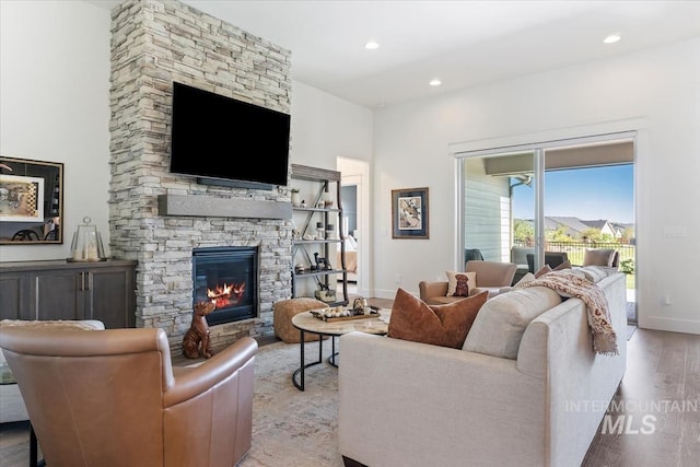 12013 W Zamalek Ct, Kuna, ID 83634 - living area with a stone fireplace, wood finished floors, baseboards, and recessed lighting