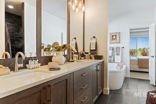 12013 W Zamalek Ct, Kuna, ID 83634 - bathroom featuring double vanity, a freestanding tub, tile patterned floors, connected bathroom, and recessed lighting