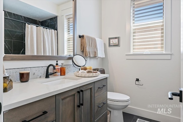 12013 W Zamalek Ct, Kuna, ID 83634 - bathroom featuring toilet, vanity, tile patterned floors, baseboards, and a shower with curtain