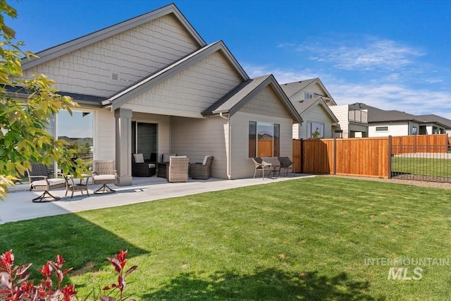 12013 W Zamalek Ct, Kuna, ID 83634 - rear view of house featuring a patio area and an outdoor hangout area