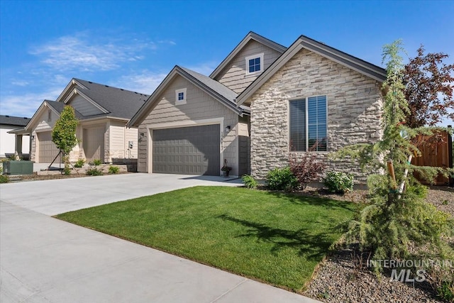 12013 W Zamalek Ct, Kuna, ID 83634 - view of front of property with stone siding, driveway, an attached garage, and a front lawn