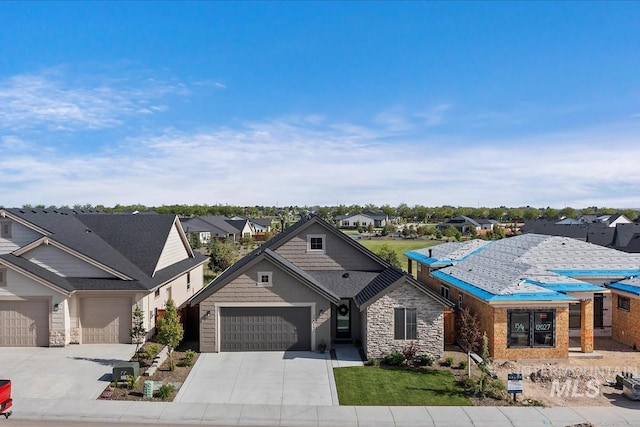 12013 W Zamalek Ct, Kuna, ID 83634 - view of front of house featuring stone siding, a residential view, driveway, and an attached garage