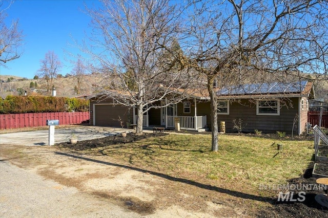 single story home with a front lawn, driveway, a porch, fence, and an attached garage