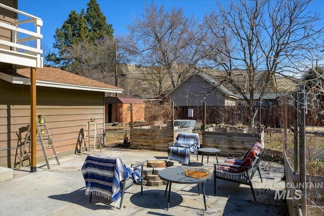 view of patio / terrace with an outdoor fire pit and fence