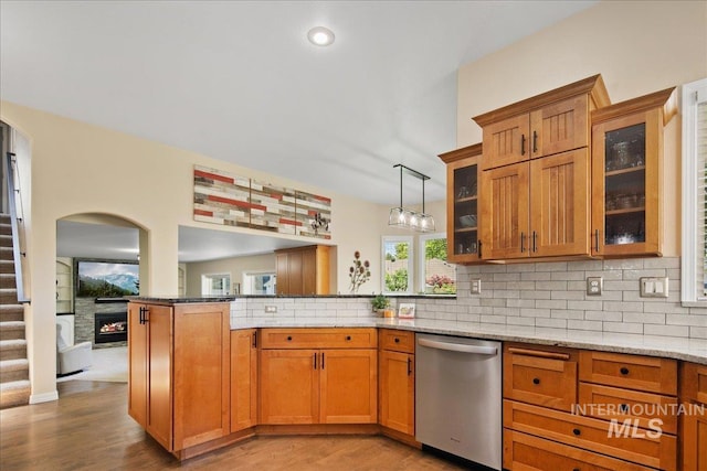 1049 N Purple Sage Way, Eagle, ID 83616 - kitchen with dishwasher, a peninsula, light wood finished floors, and brown cabinets