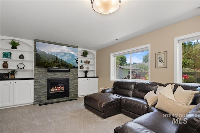1049 N Purple Sage Way, Eagle, ID 83616 - living room with healthy amount of natural light, a stone fireplace, light carpet, and built in features