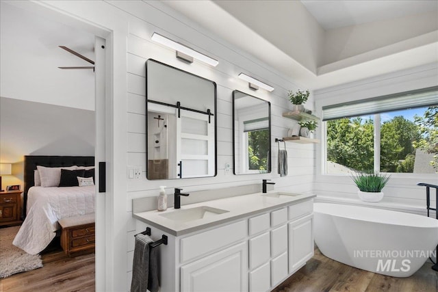 1049 N Purple Sage Way, Eagle, ID 83616 - full bath featuring wood finished floors, a freestanding bath, double vanity, and ensuite bath