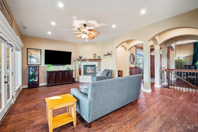 4965 S Nickel Creek Ave, Meridian, ID 83642 - living area with arched walkways, recessed lighting, a glass covered fireplace, and ceiling fan