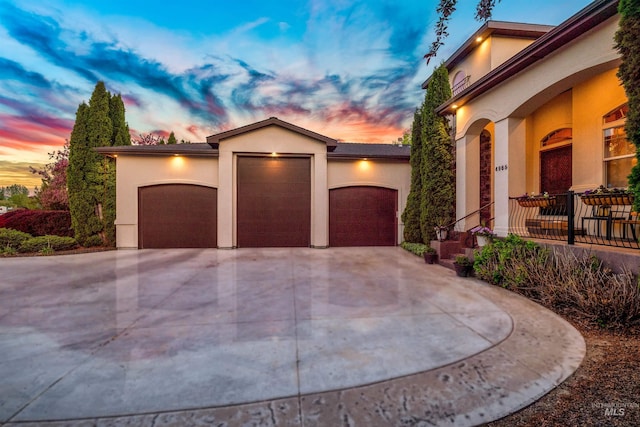 4965 S Nickel Creek Ave, Meridian, ID 83642 - mediterranean / spanish-style home with concrete driveway, an attached garage, and stucco siding