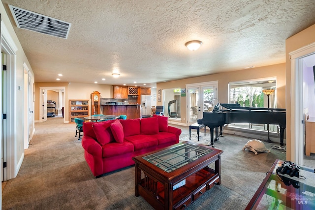 4965 S Nickel Creek Ave, Meridian, ID 83642 - carpeted living area with a textured ceiling, french doors, visible vents, and recessed lighting