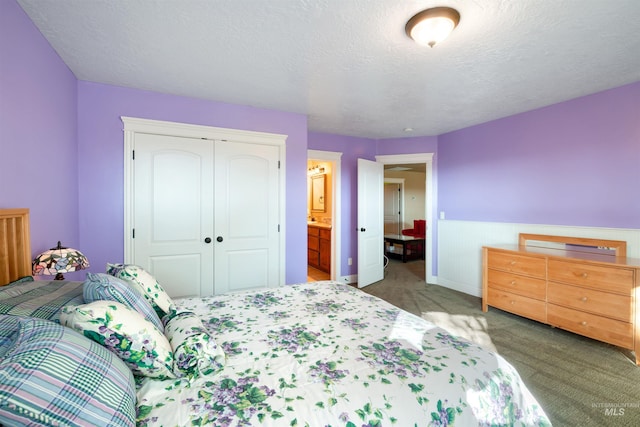 4965 S Nickel Creek Ave, Meridian, ID 83642 - carpeted bedroom with a closet, a textured ceiling, ensuite bath, and a wainscoted wall