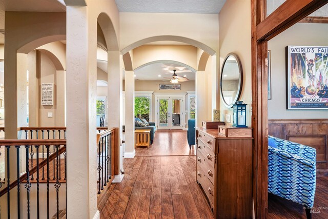 4965 S Nickel Creek Ave, Meridian, ID 83642 - corridor featuring hardwood / wood-style flooring, arched walkways, a wainscoted wall, and an upstairs landing
