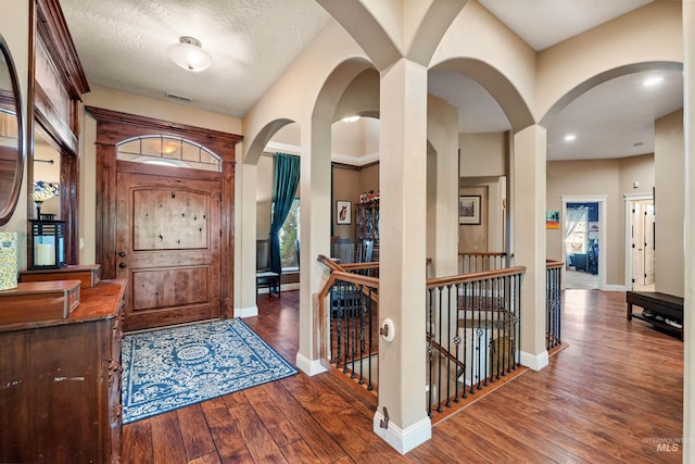 4965 S Nickel Creek Ave, Meridian, ID 83642 - entrance foyer featuring visible vents, baseboards, arched walkways, and hardwood / wood-style flooring