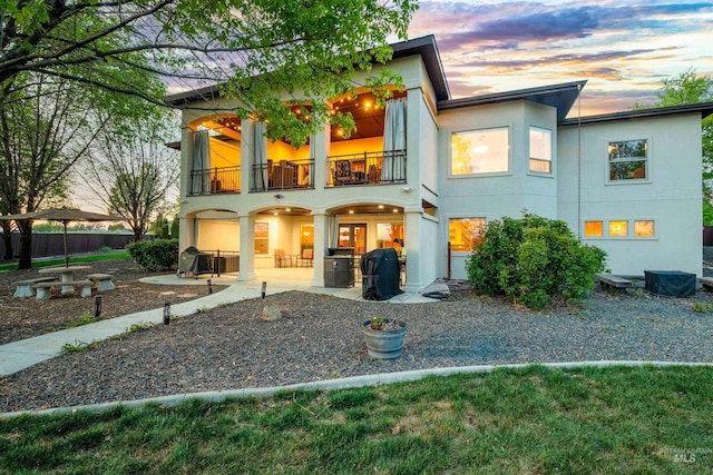 4965 S Nickel Creek Ave, Meridian, ID 83642 - rear view of property with fence, a patio, stucco siding, and a balcony