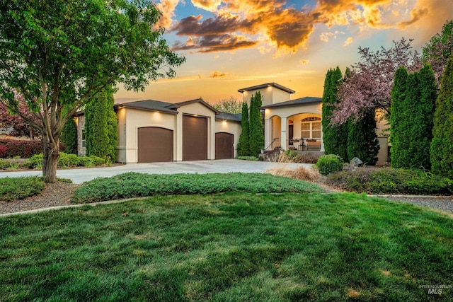 4965 S Nickel Creek Ave, Meridian, ID 83642 - mediterranean / spanish-style house with concrete driveway, a front yard, stucco siding, and a garage