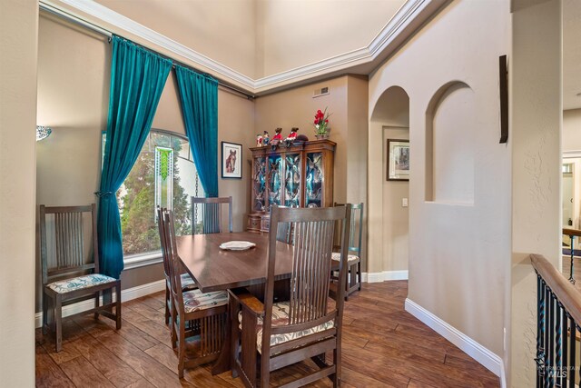4965 S Nickel Creek Ave, Meridian, ID 83642 - dining space featuring baseboards, hardwood / wood-style floors, and arched walkways