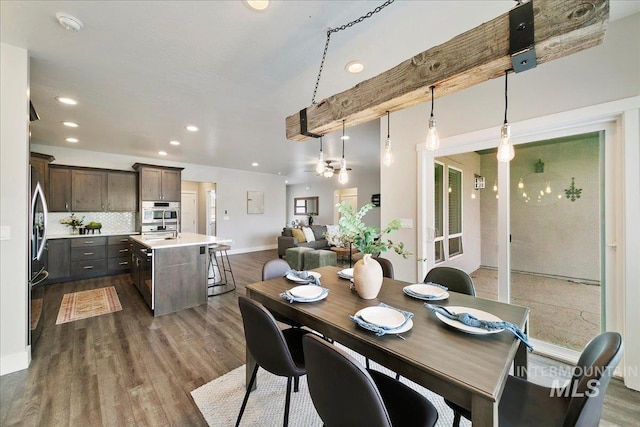 dining area with dark wood finished floors, recessed lighting, and baseboards