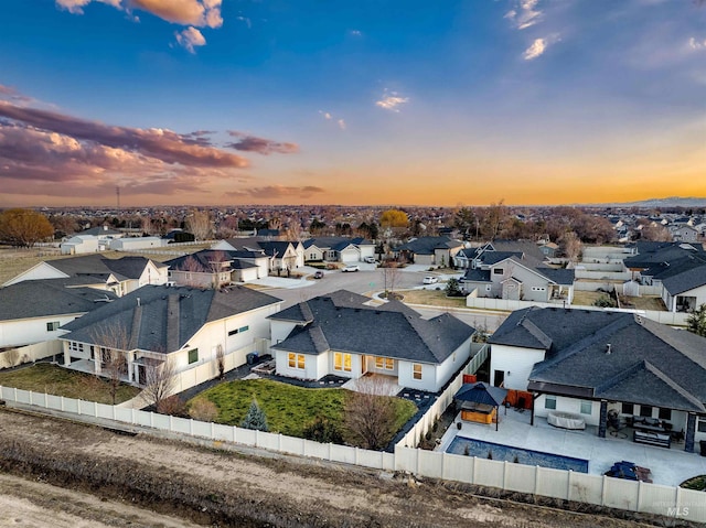 aerial view at dusk featuring a residential view