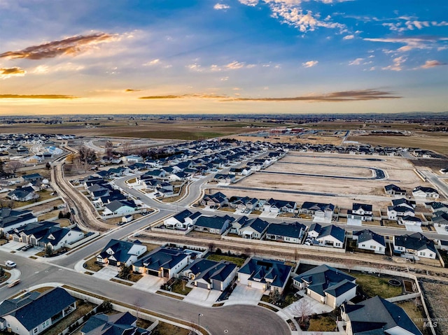 aerial view at dusk featuring a residential view