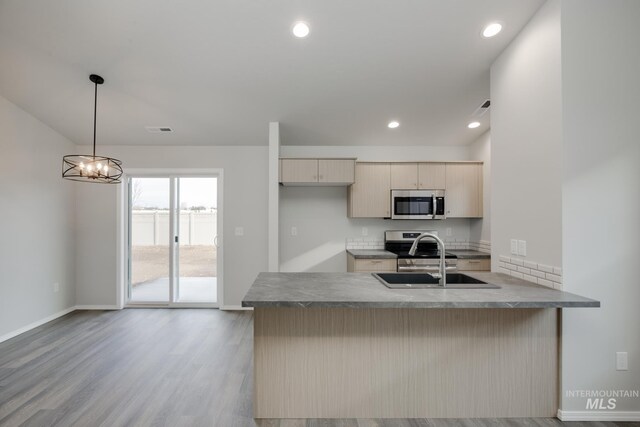 11069 Canvas St, Caldwell, ID 83605 - kitchen with a sink, visible vents, a peninsula, appliances with stainless steel finishes, and wood finished floors