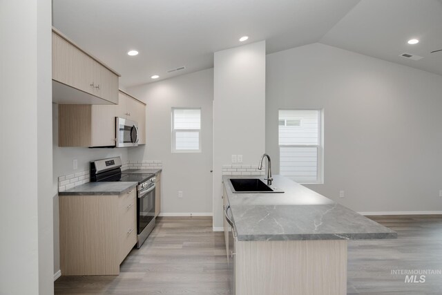 11069 Canvas St, Caldwell, ID 83605 - kitchen with visible vents, a peninsula, stainless steel appliances, lofted ceiling, and a sink