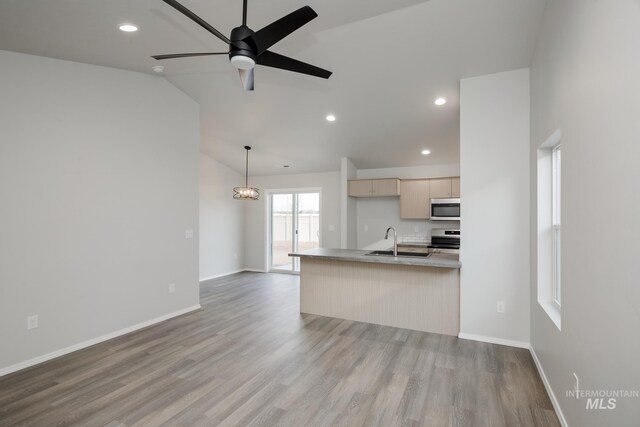 11069 Canvas St, Caldwell, ID 83605 - kitchen with a sink, stainless steel appliances, light wood-style floors, and open floor plan