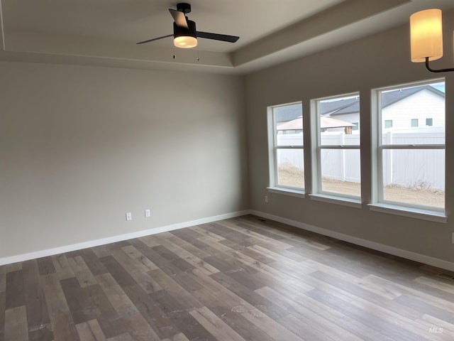 467 Hope Ave, Twin Falls, ID 83301 - unfurnished room with wood finished floors, ceiling fan, and baseboards