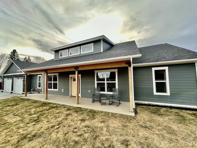 1321 Lande Ln, Moscow, ID 83843 - rear view of house with an attached garage, a lawn, and roof with shingles
