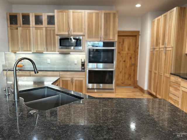 1321 Lande Ln, Moscow, ID 83843 - kitchen with a sink, stainless steel appliances, tasteful backsplash, and light brown cabinetry